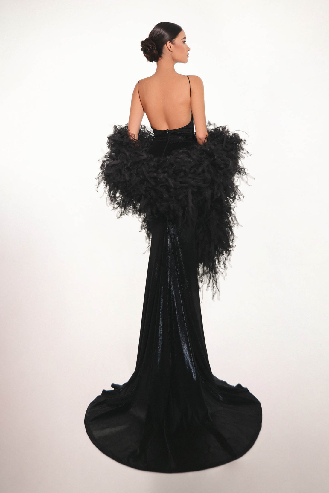Back view of elegant black floral dress with long train and hand-crafted details