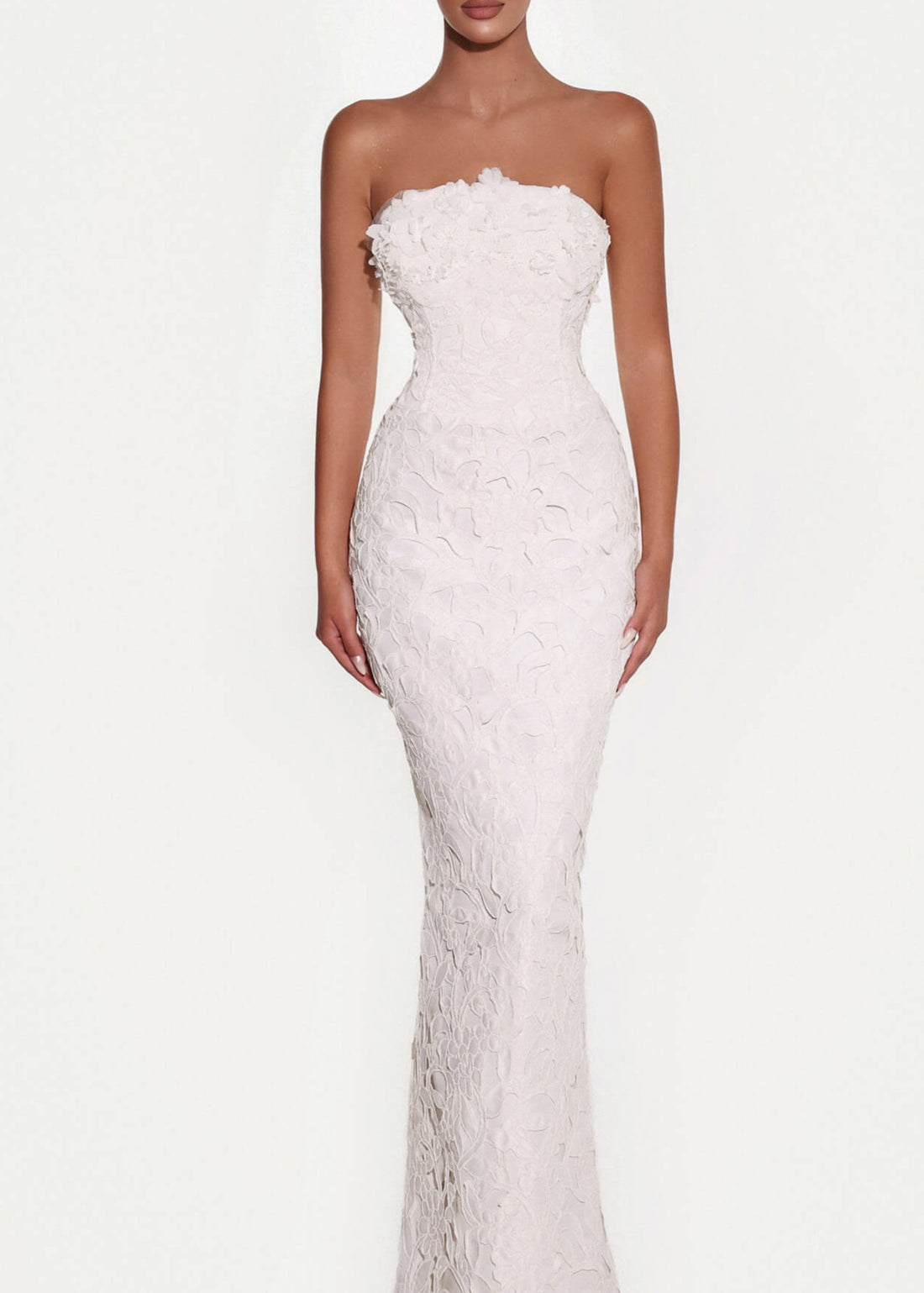 Woman wearing a strapless white wedding dress on a white background