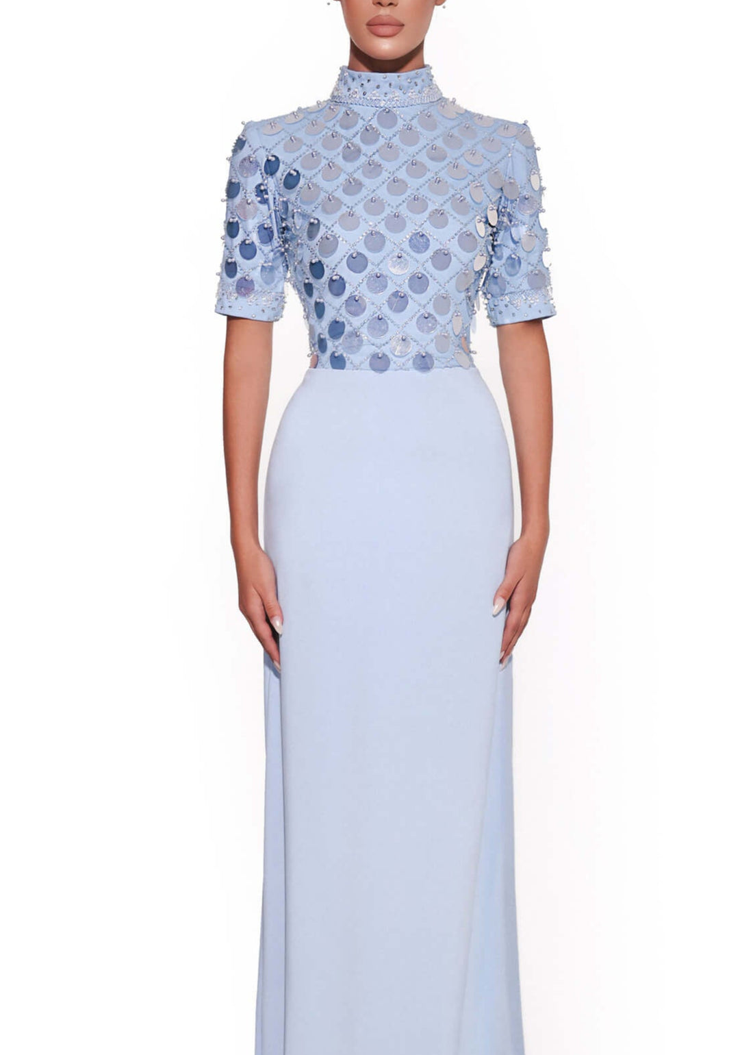 Woman wearing a light blue dress with a patterned top on a white background