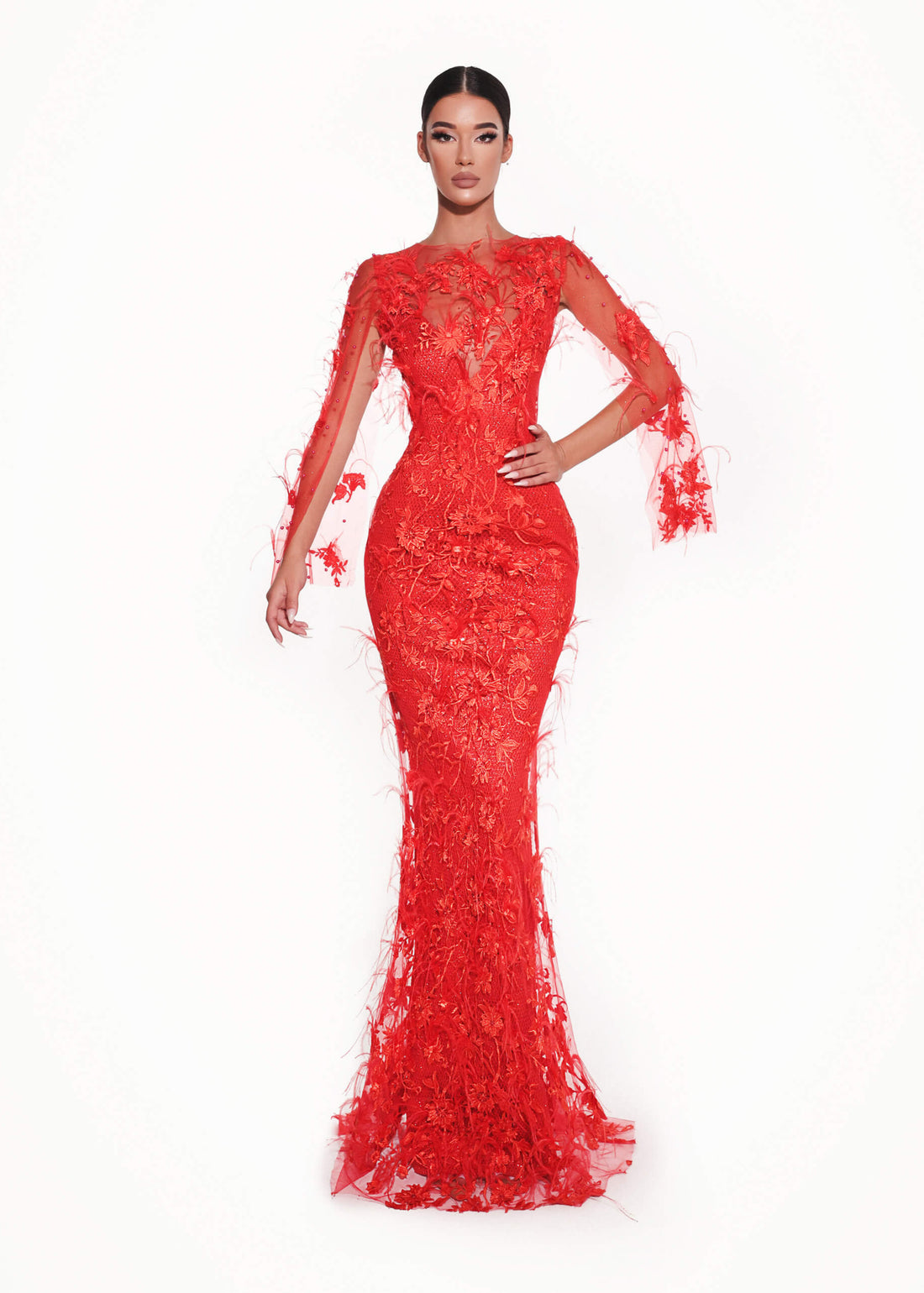 Red evening gown with sheer sleeves on a white background