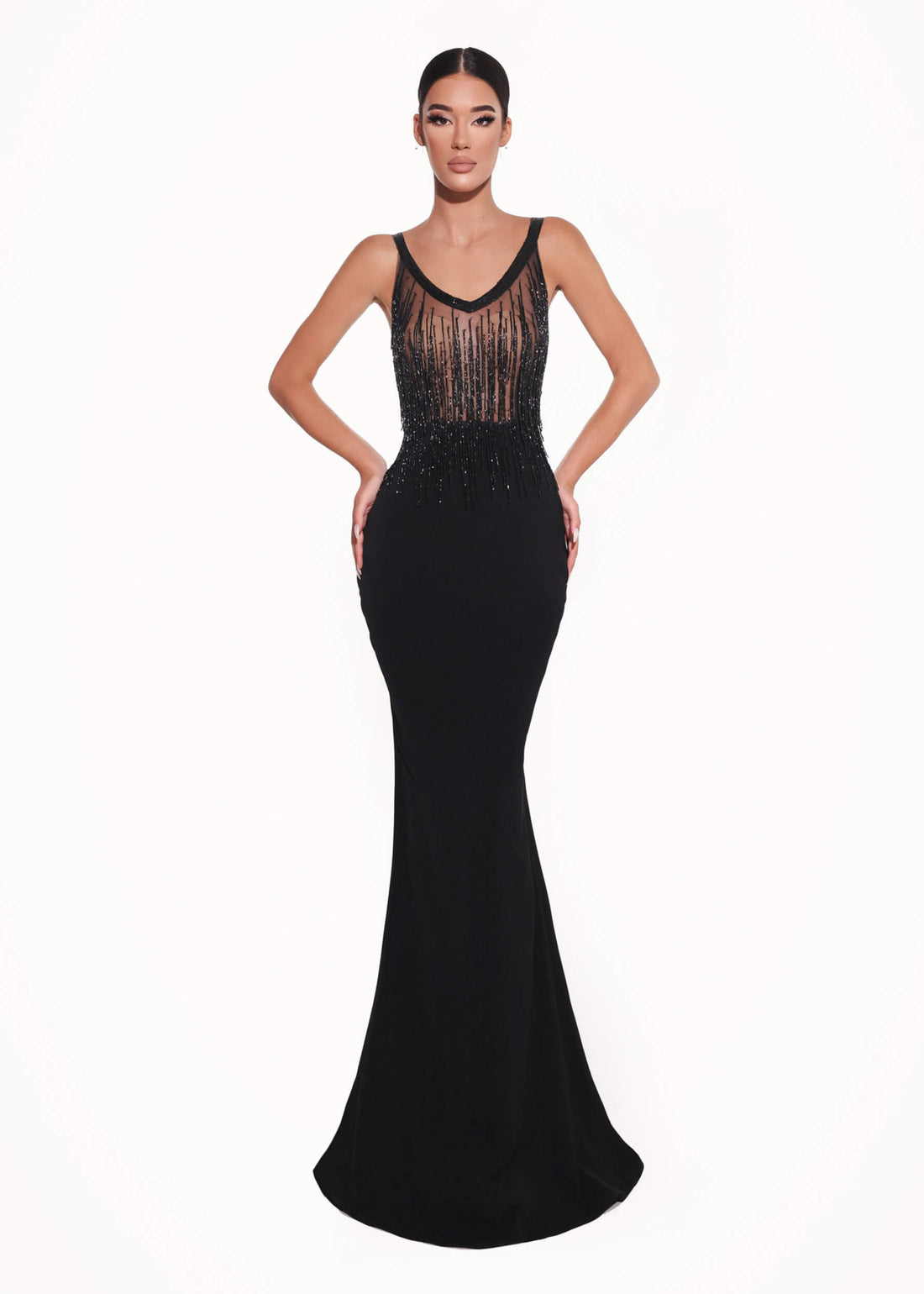 Black evening gown with sheer lace detailing on a white background