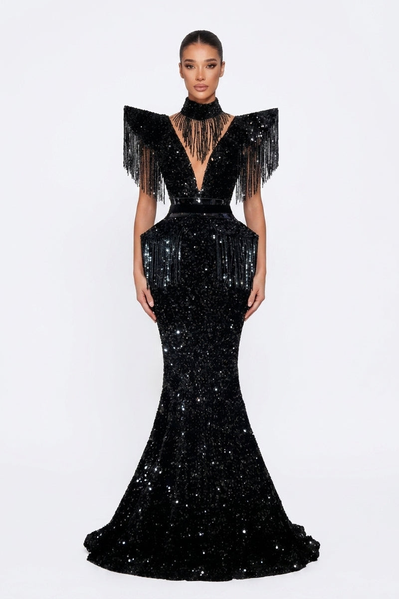 Black evening gown with fringe details on a white background