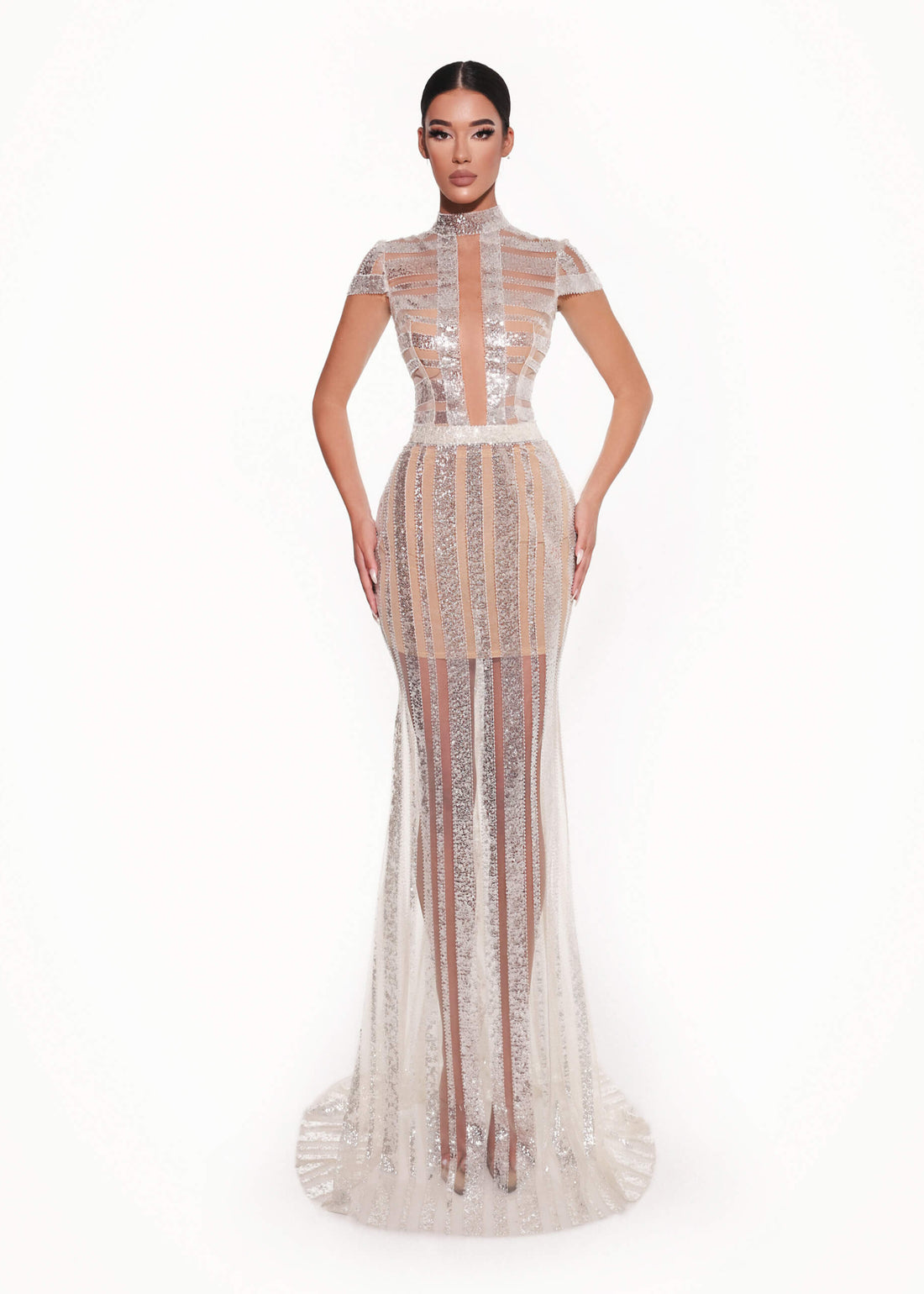 Woman wearing a sheer, high-neck evening gown on a white background