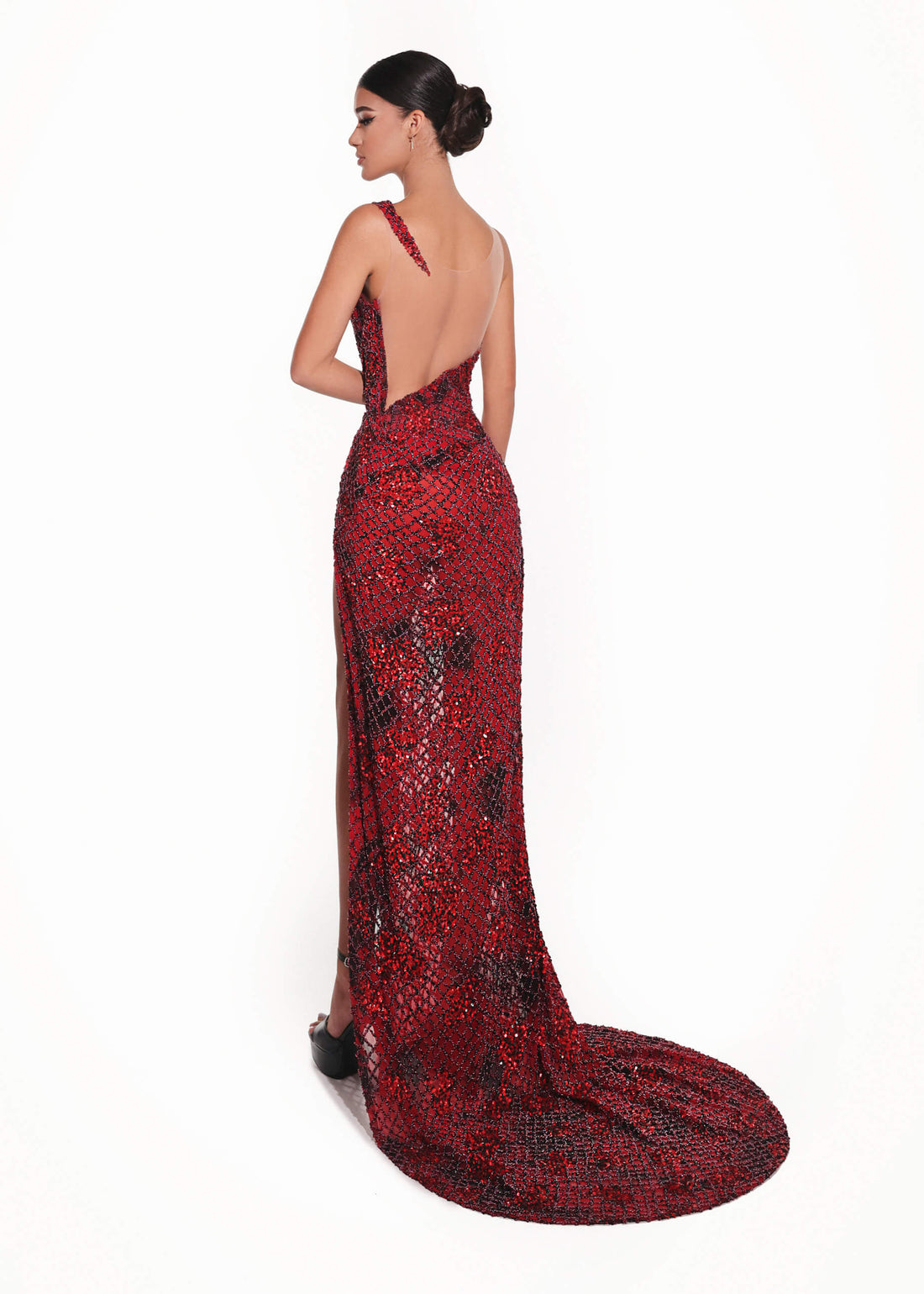 Red evening gown with a long train on a white background