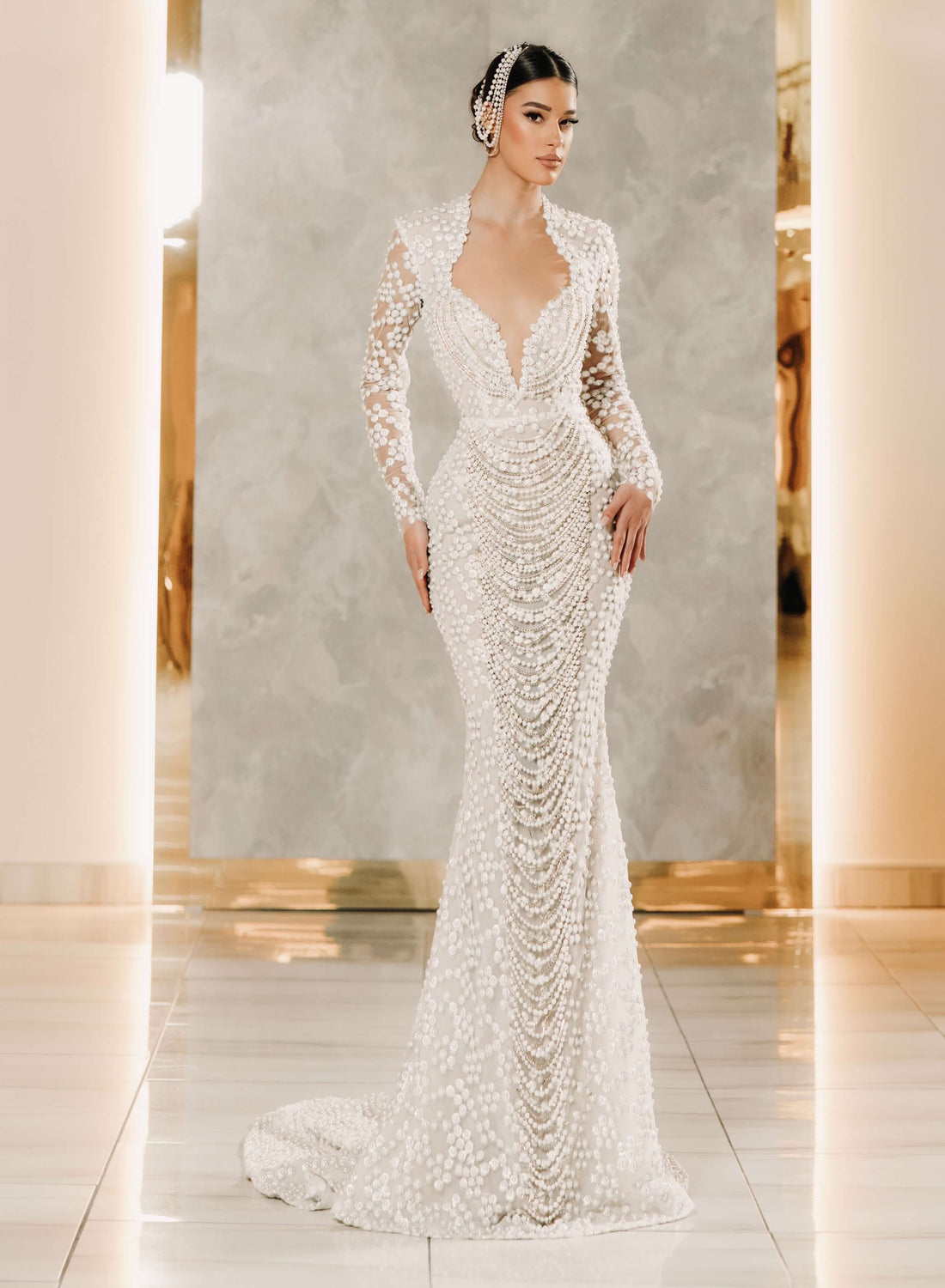 Woman wearing a beaded wedding dress in an elegant indoor setting