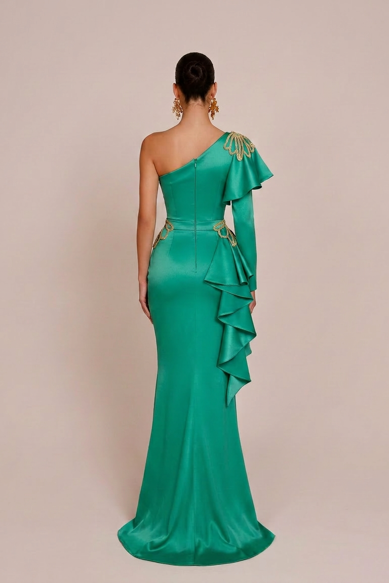 Green one-shoulder evening gown with ruffled details on a beige background