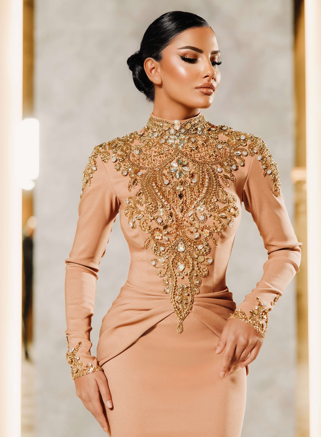 close up detail of handmade gold crystal embroidery and beaded embellishments on couture gown